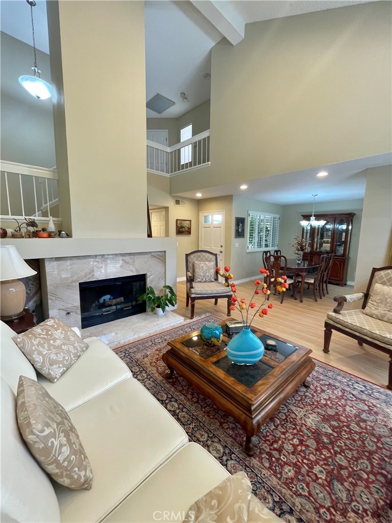 a living room with furniture a fireplace and a table