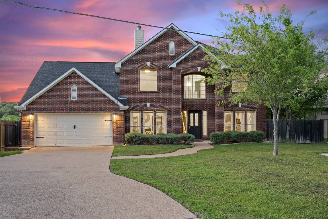 a front view of a house with a yard and garage