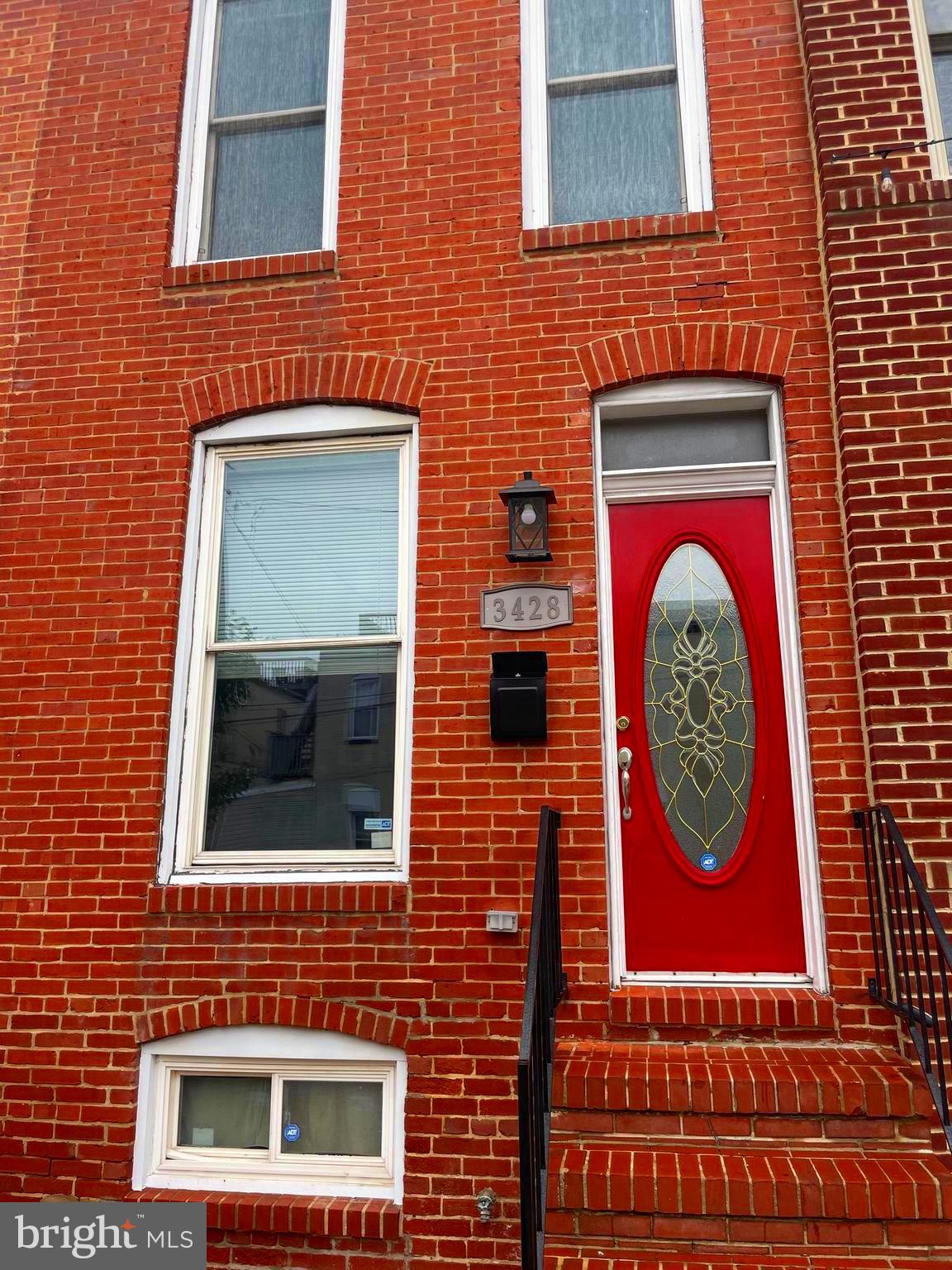 a brick building with four windows