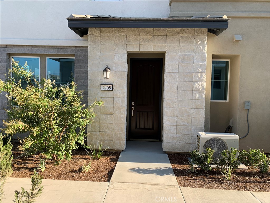 a stone house with potted plants in front of door