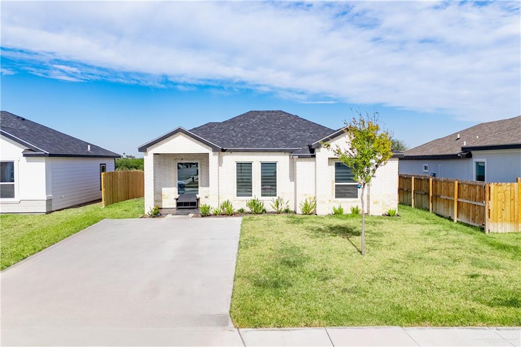 View of front facade with a front yard and a patio area