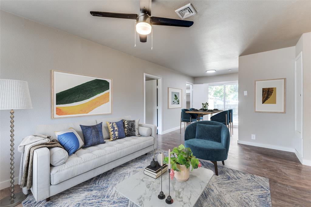 a living room with furniture and a wooden floor