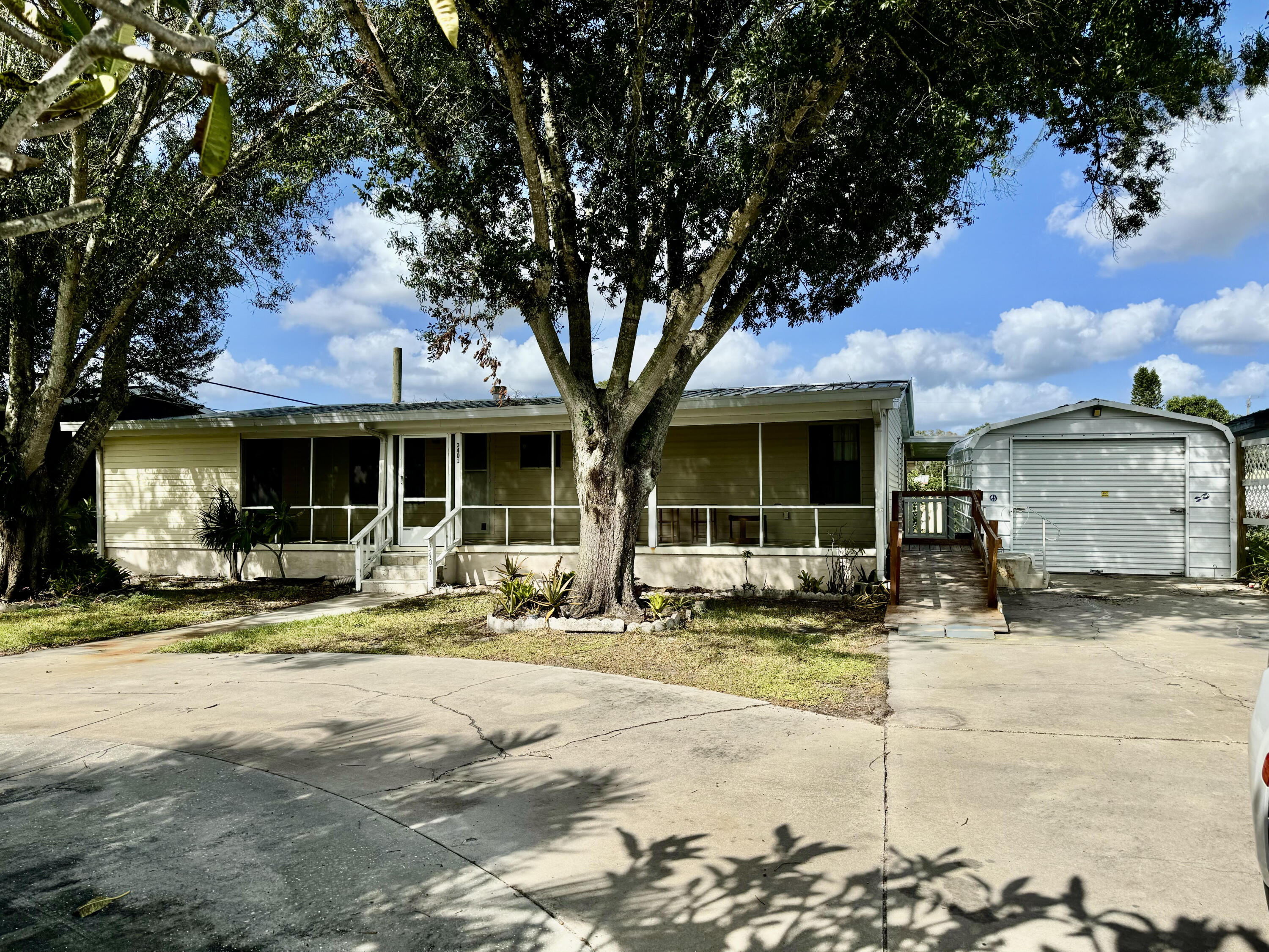 a front view of a house with a garden and sitting area