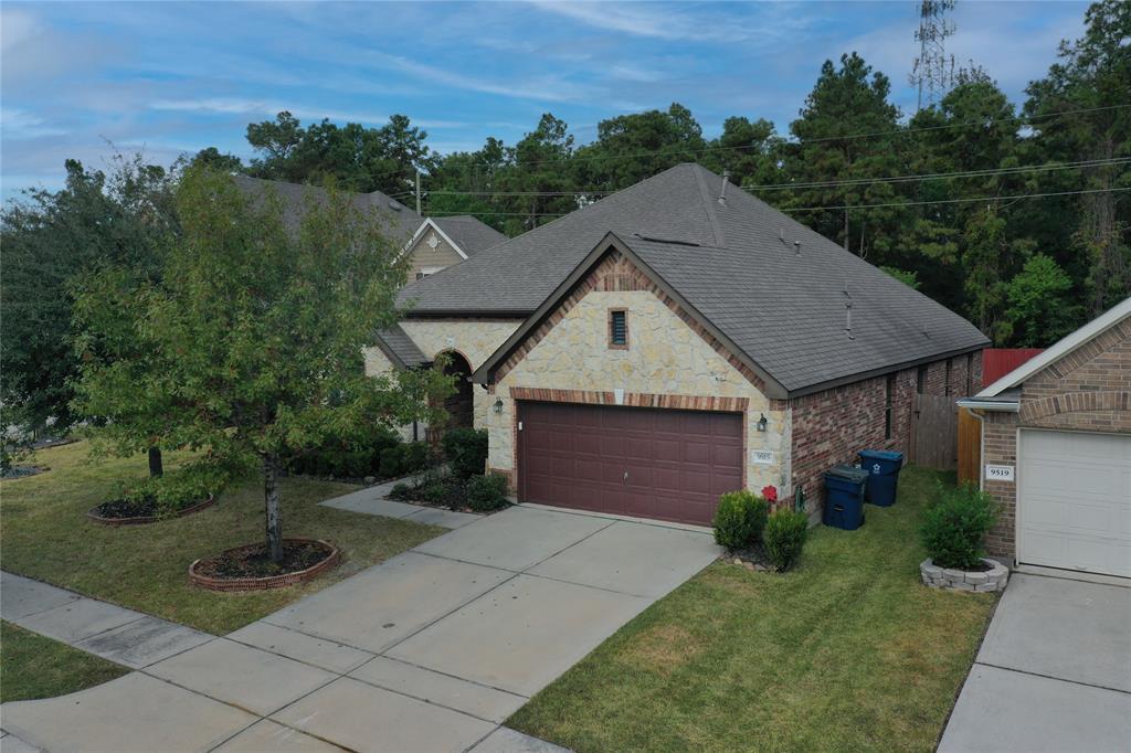 a aerial view of a house next to a yard