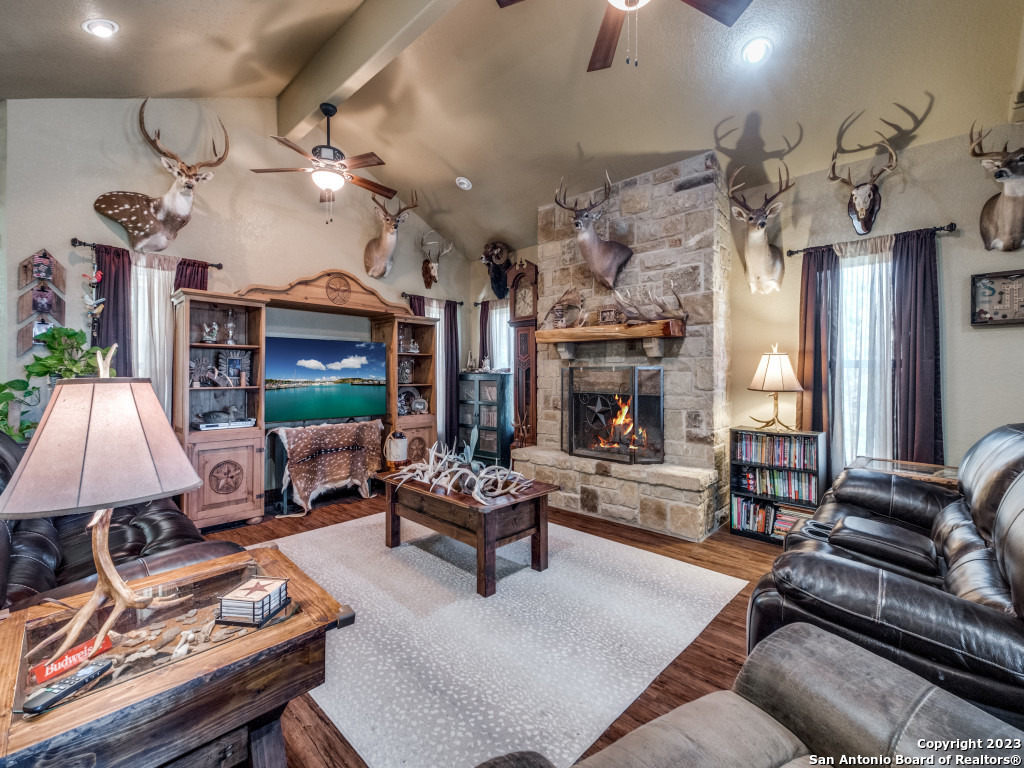 a living room with fireplace furniture and a chandelier