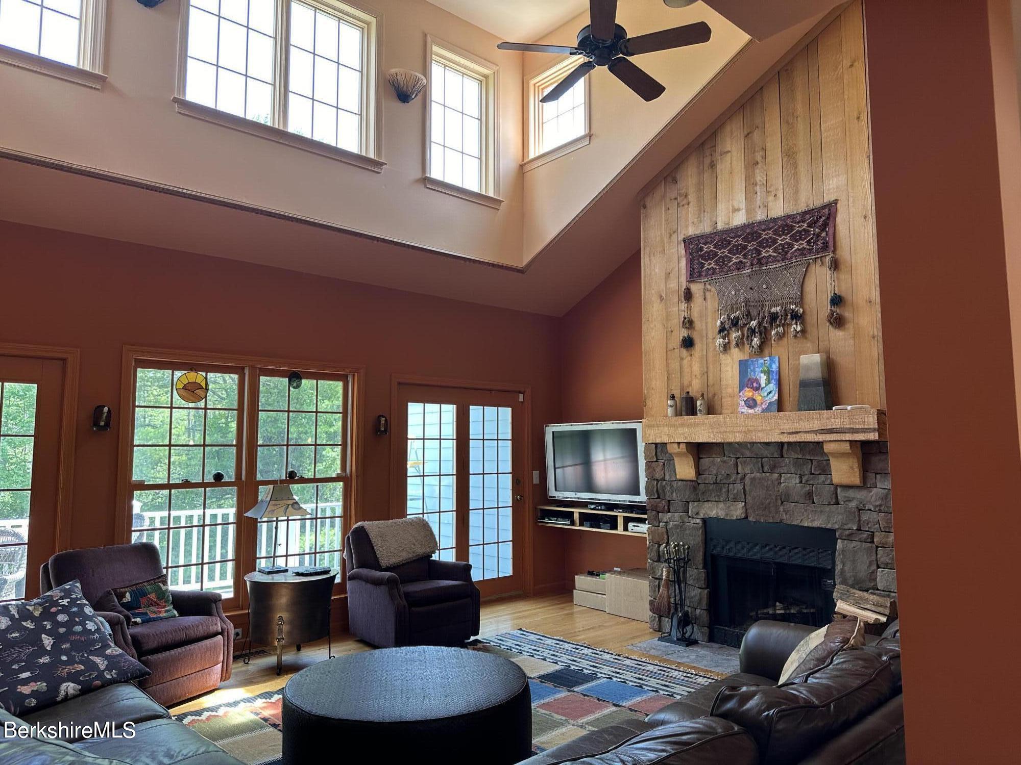 a living room with furniture fireplace and a large window