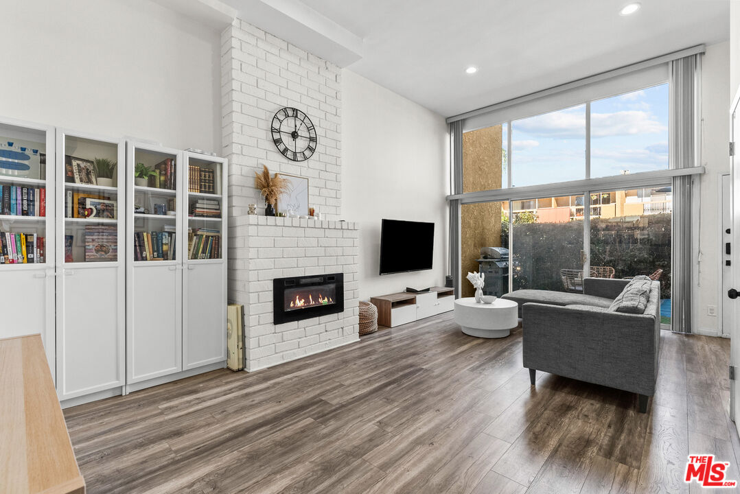 a living room with furniture fireplace and flat screen tv