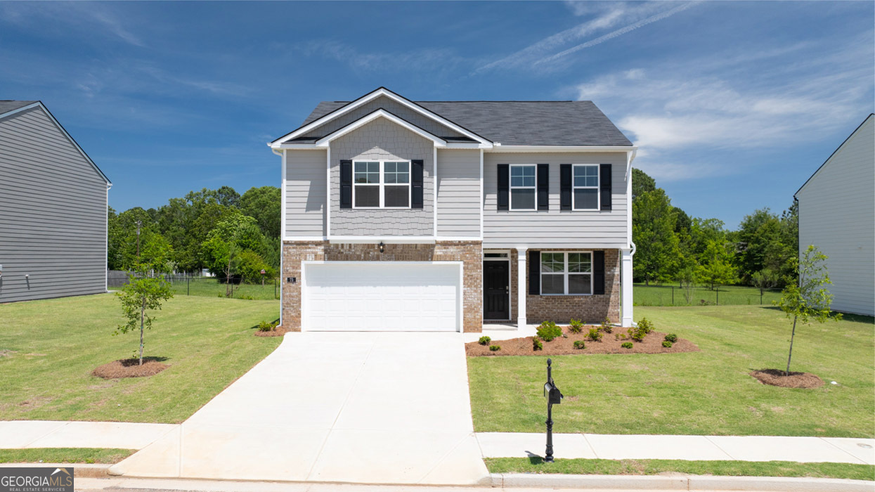 a front view of a house with a yard