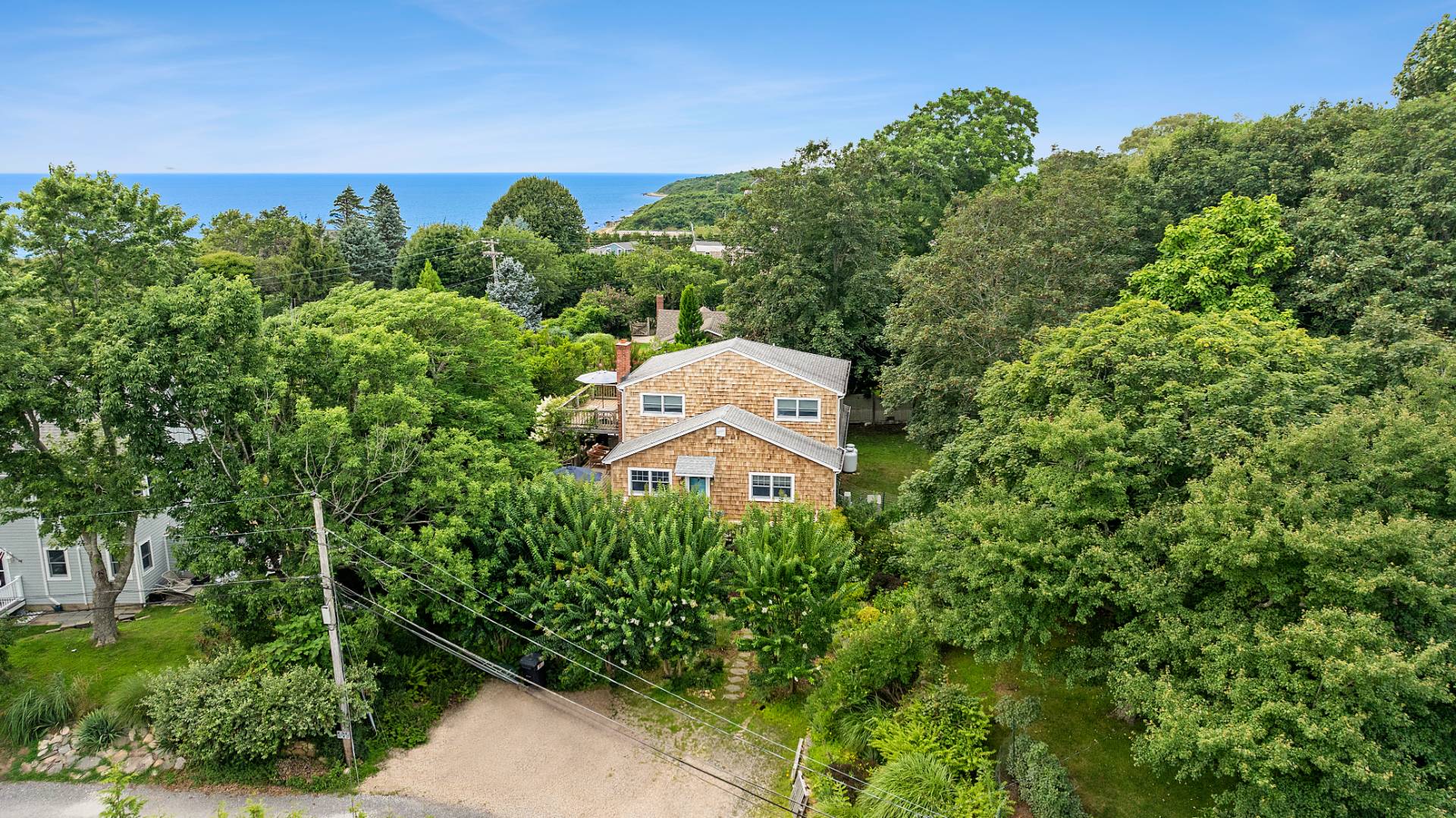 an aerial view of a house with a yard and lake view