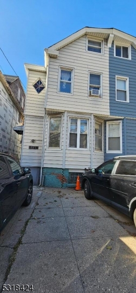 a view of a car park in front of a house