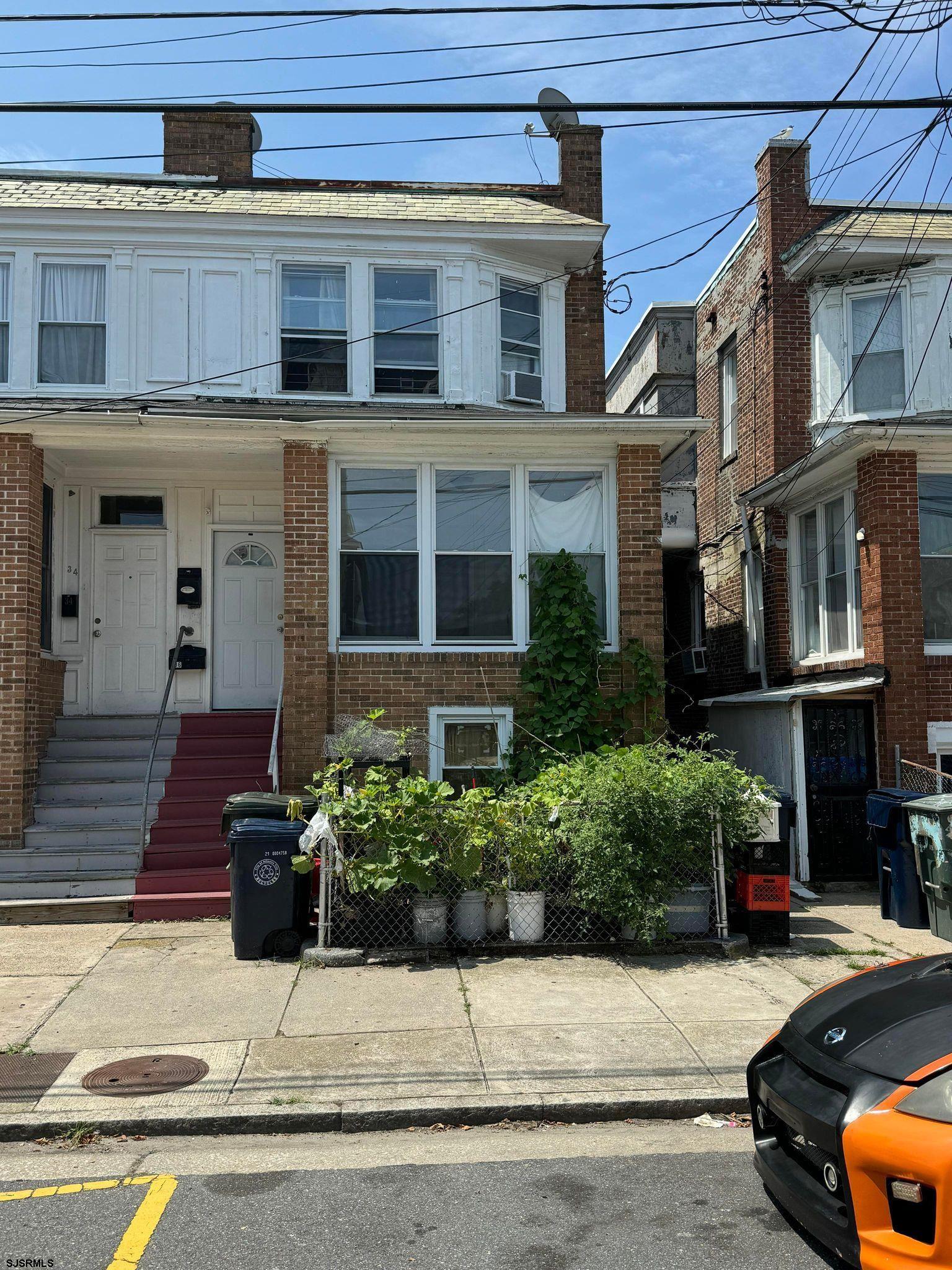 a view of a building with a yard and sitting space