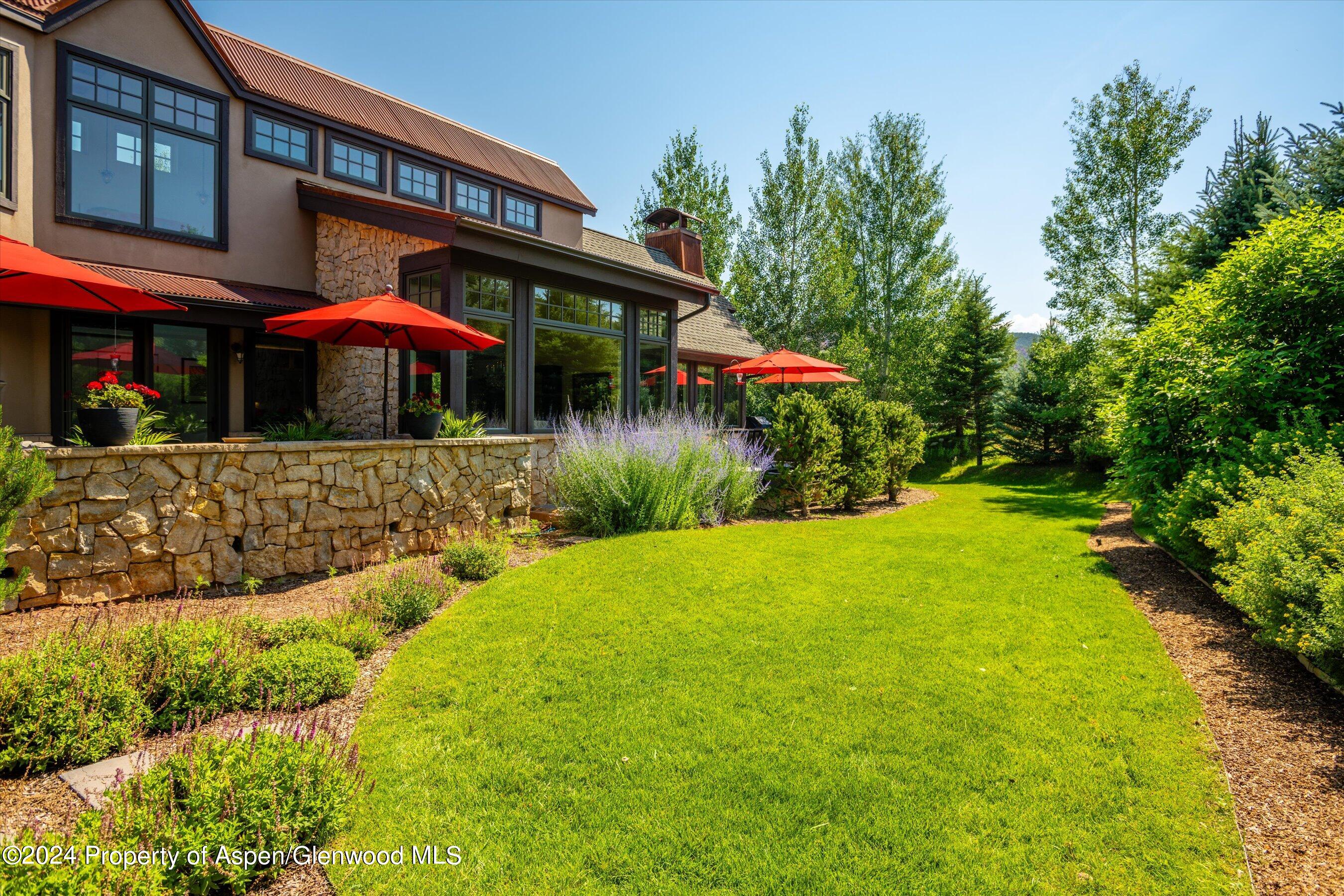 a view of a house with pool and sitting area