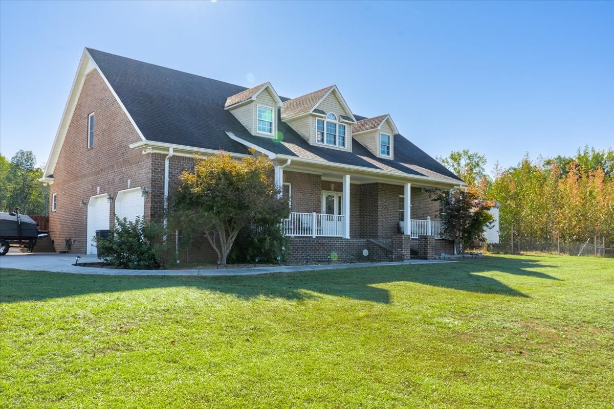 a front view of house with yard and green space