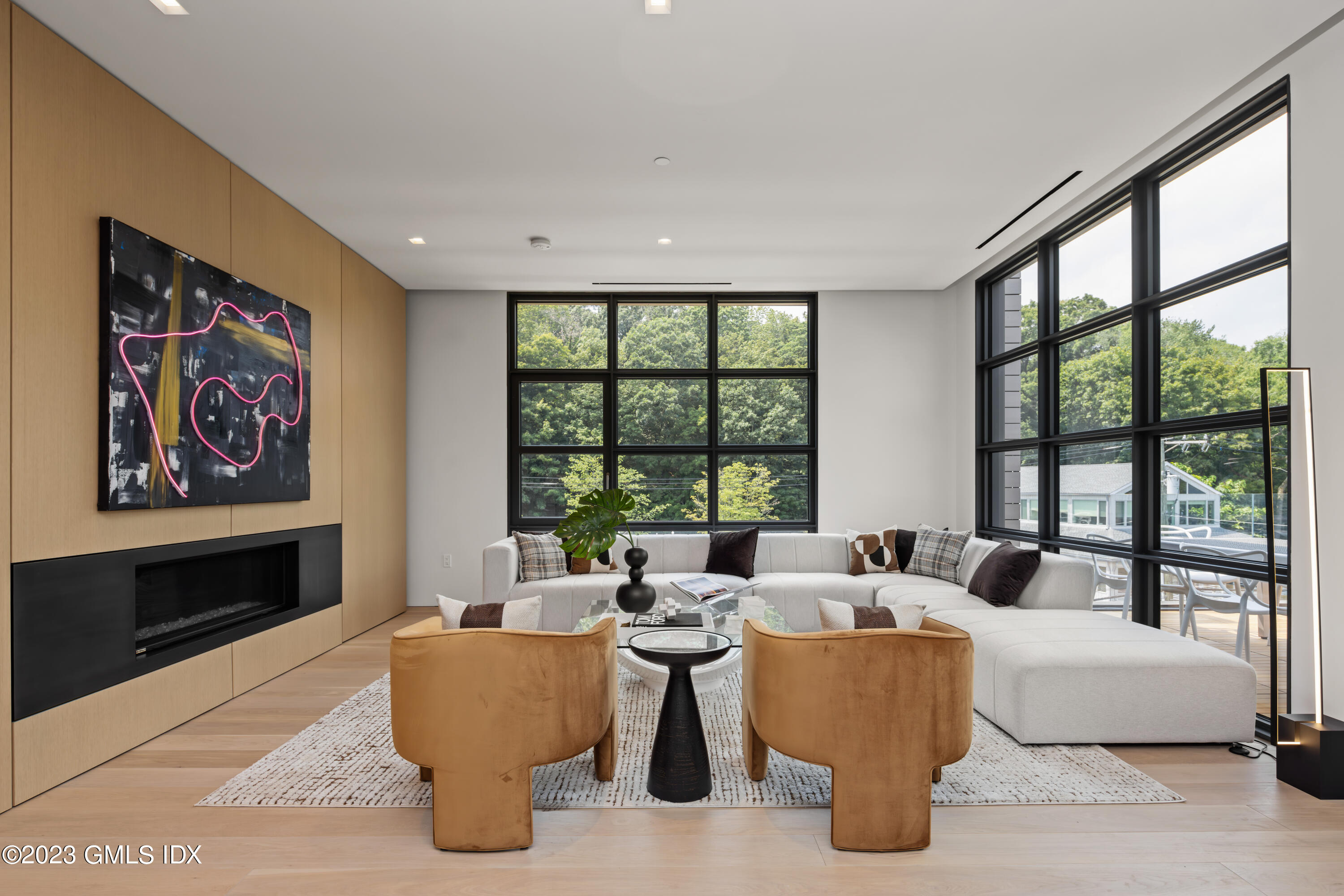 a living room with couches and a floor to ceiling window