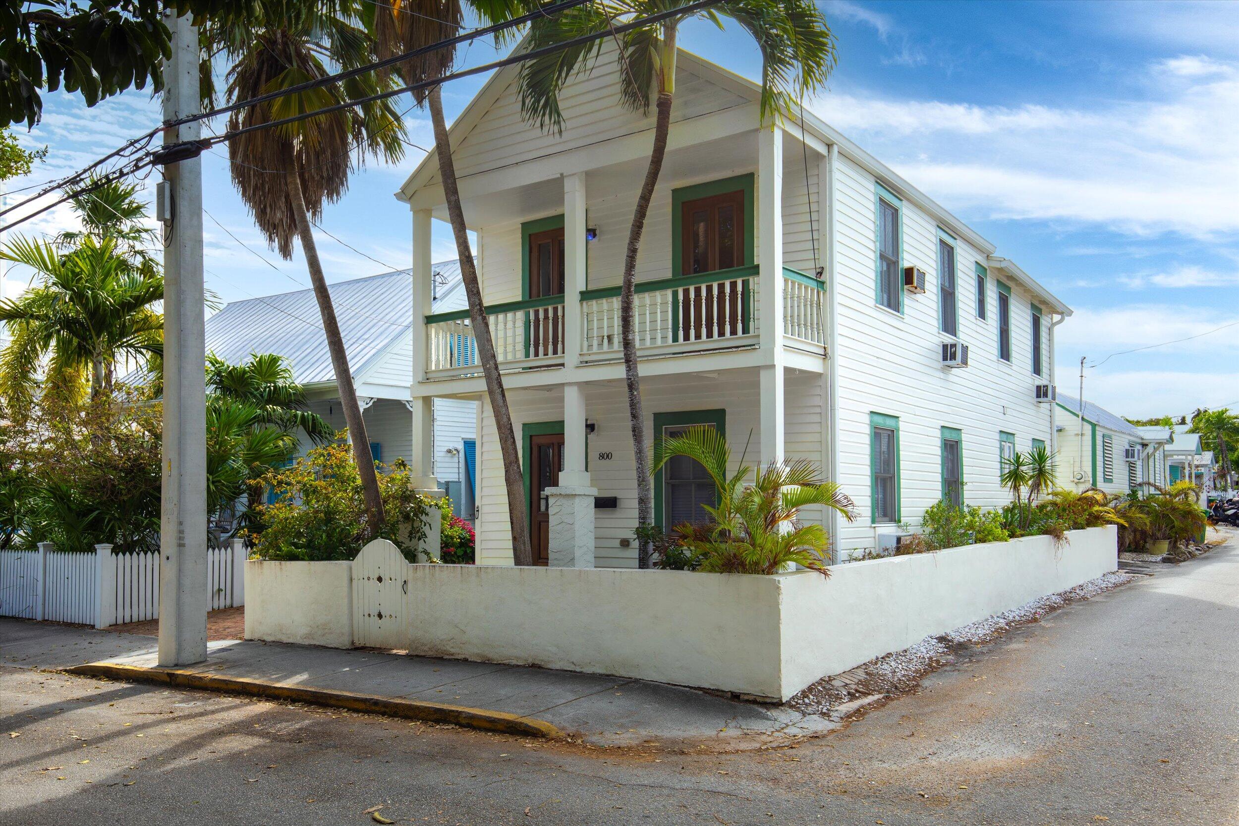 a view of a white apartments with large windows