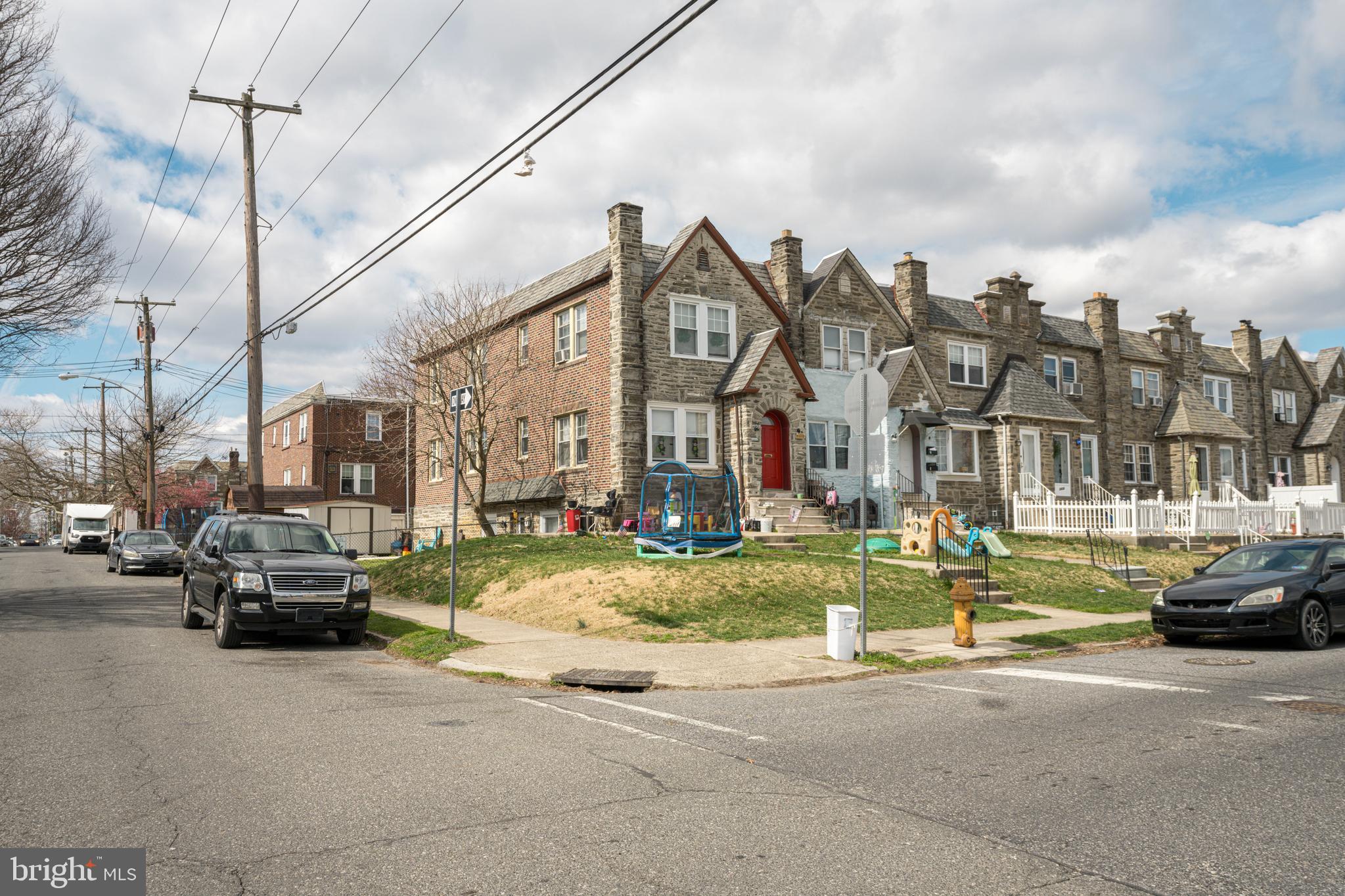 a view of a city street with parked cars