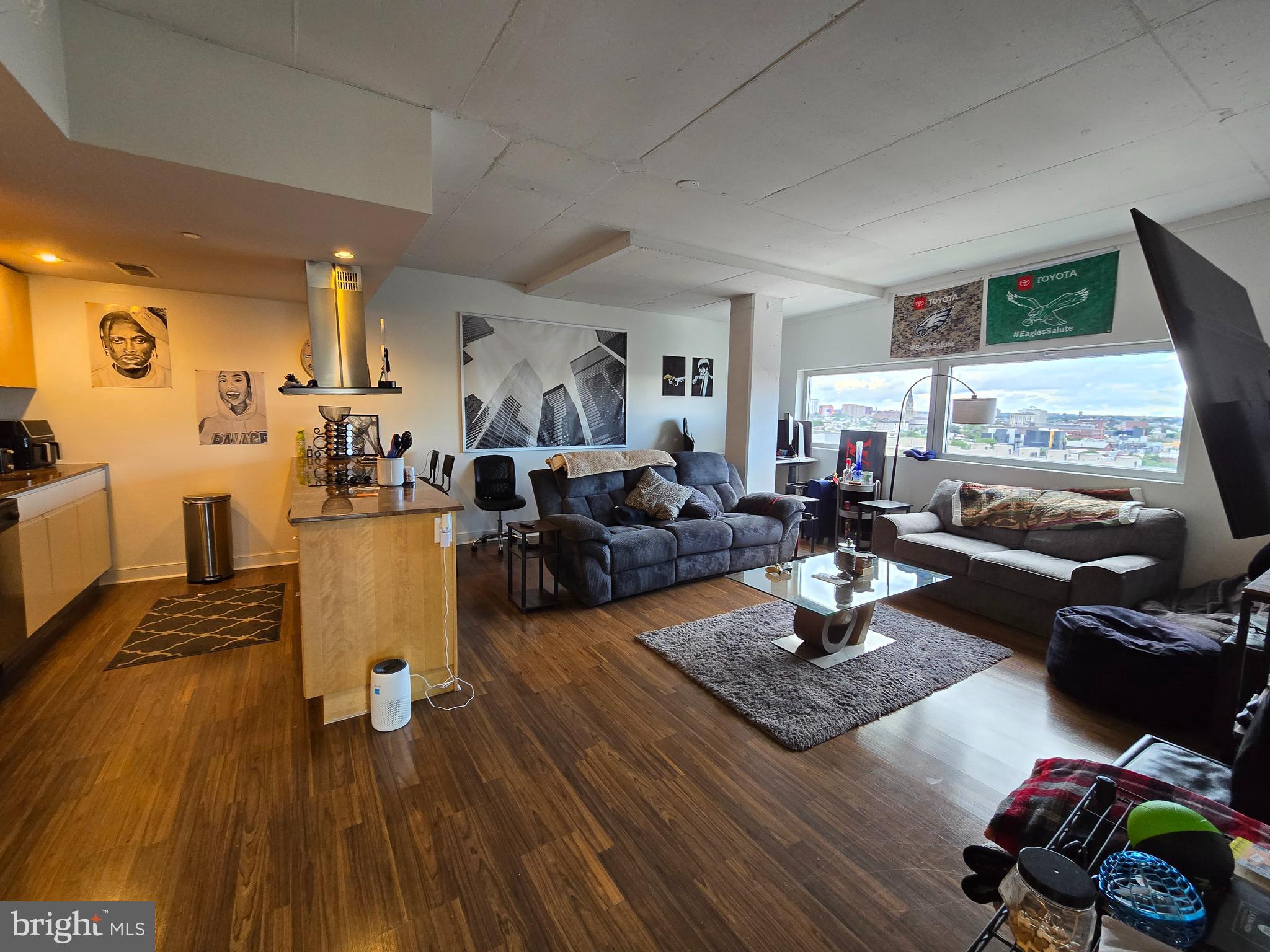 a living room with furniture hard wood floor and a table