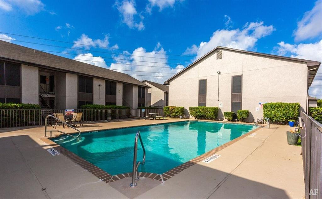 a view of a house with backyard patio and swimming pool