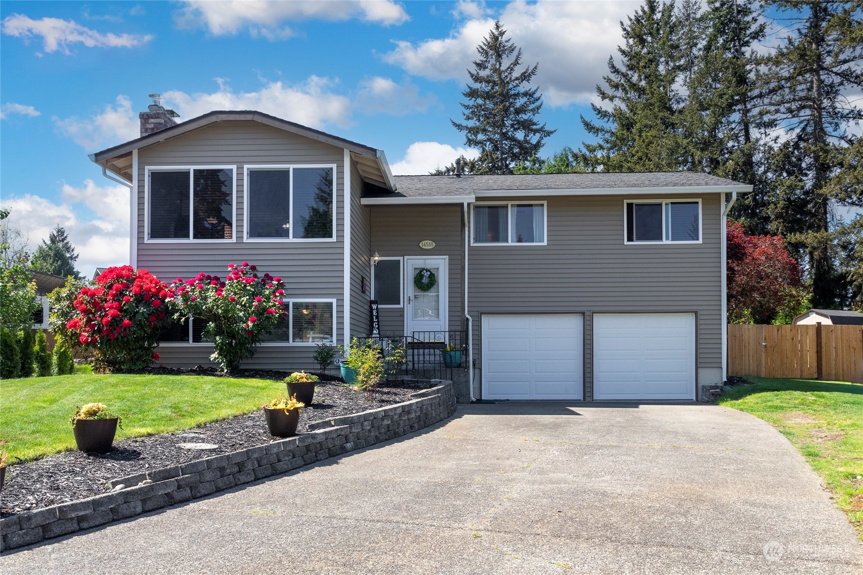 a front view of a house with a yard and garage