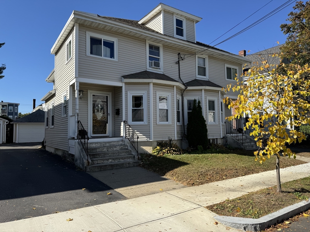 a front view of a house with garden