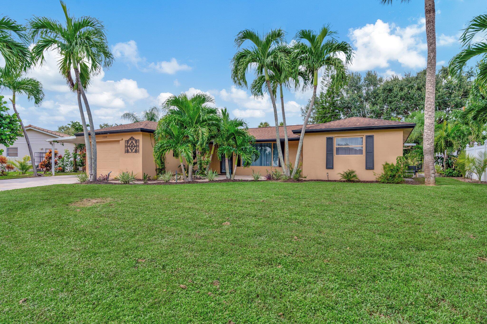 a front view of house with yard and green space