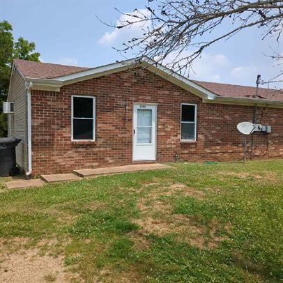 a brick house with a yard