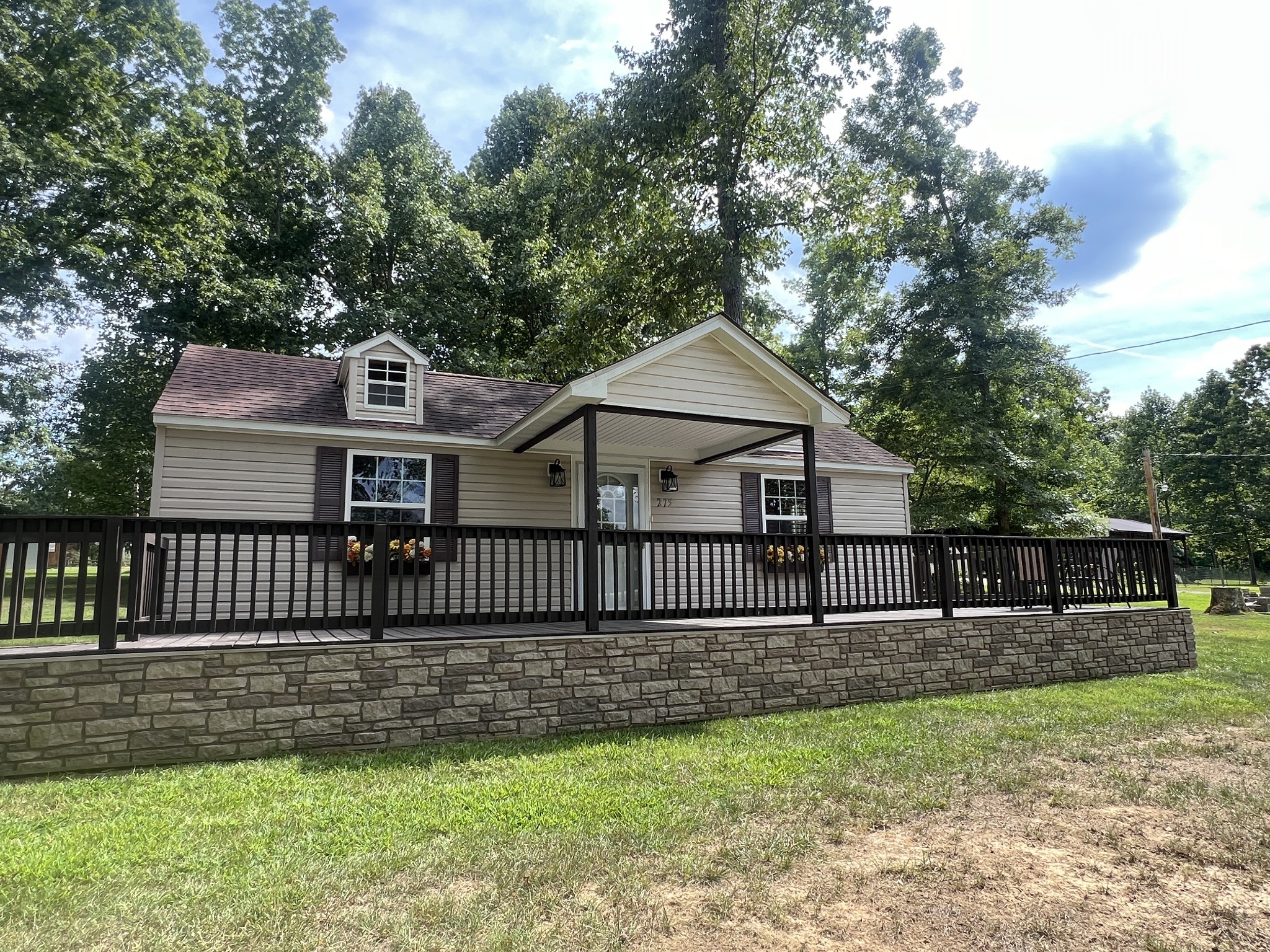 a view of a house with a yard and a garden