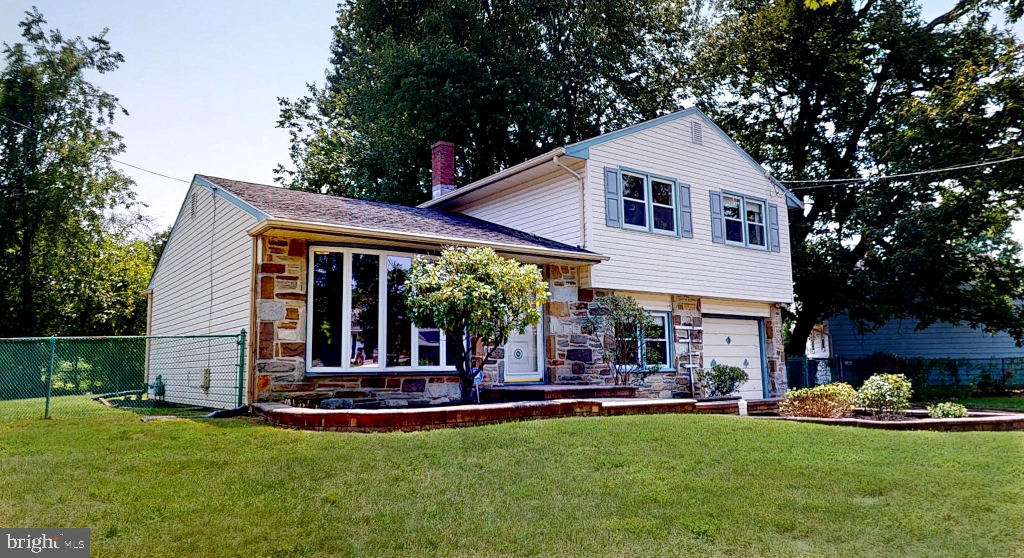 a view of a house with a yard patio and fire pit