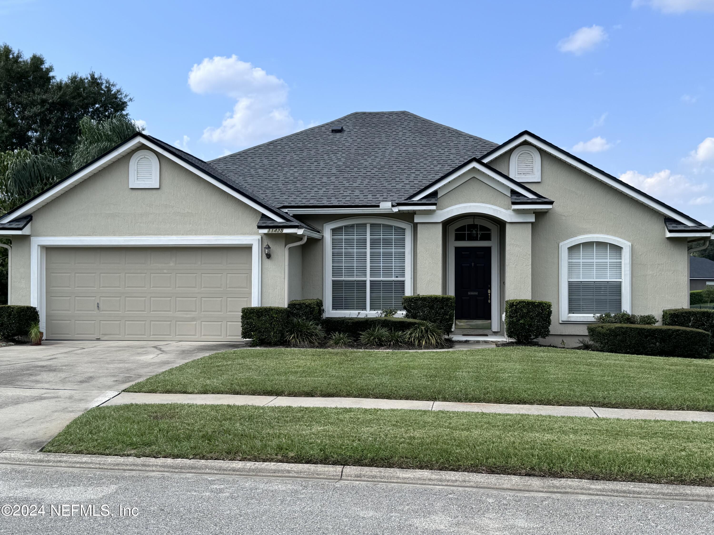 a front view of a house with a yard