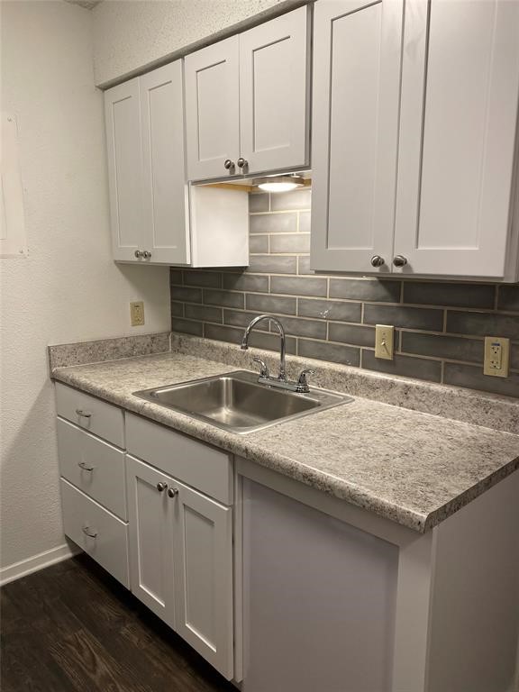 a kitchen with a sink and cabinets