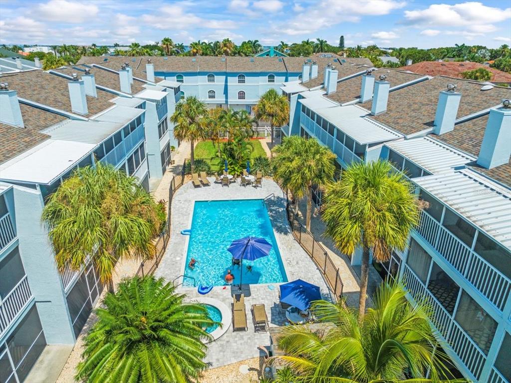 an aerial view of residential houses with outdoor space and ocean view