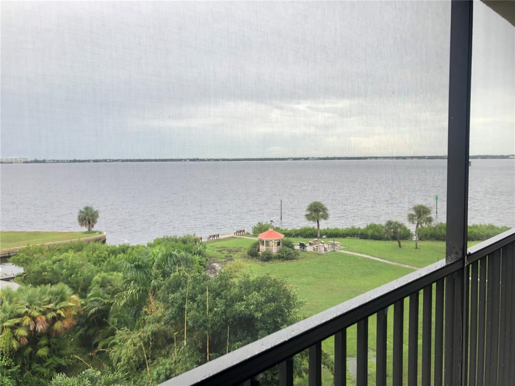 a view of a balcony with lake view and mountain view