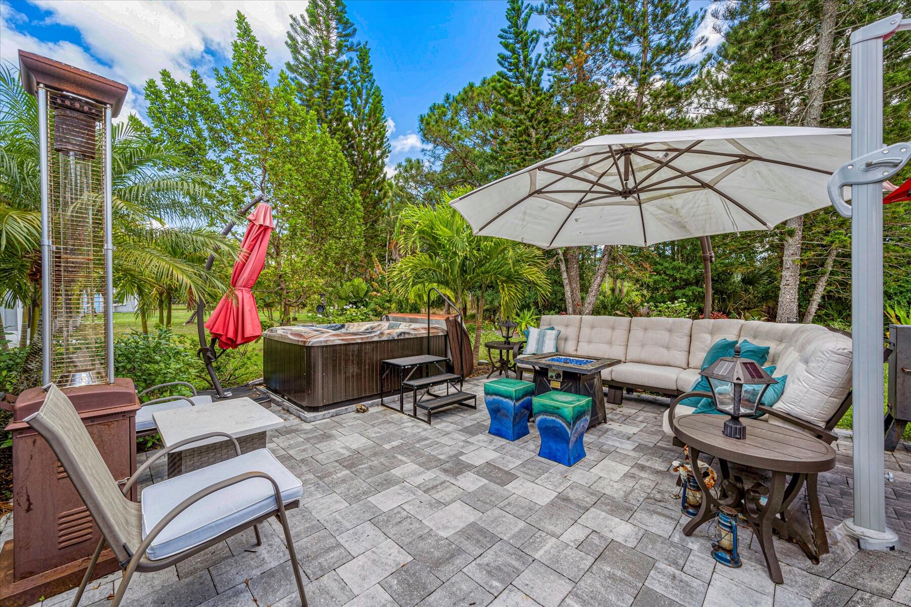 a view of a chairs and table in backyard