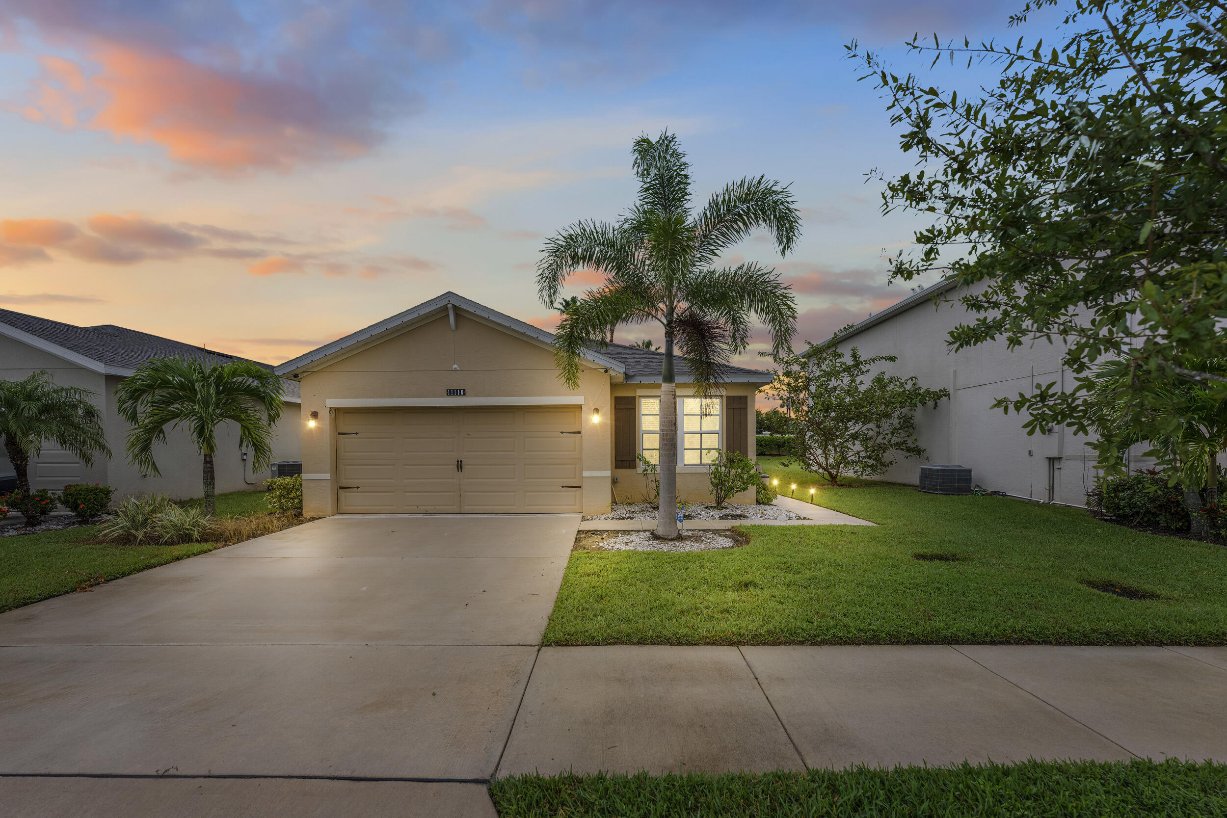 a front view of a house with a yard and garage