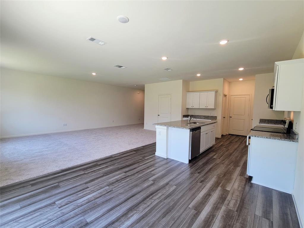 a large kitchen with a lot of counter space and stainless steel appliances