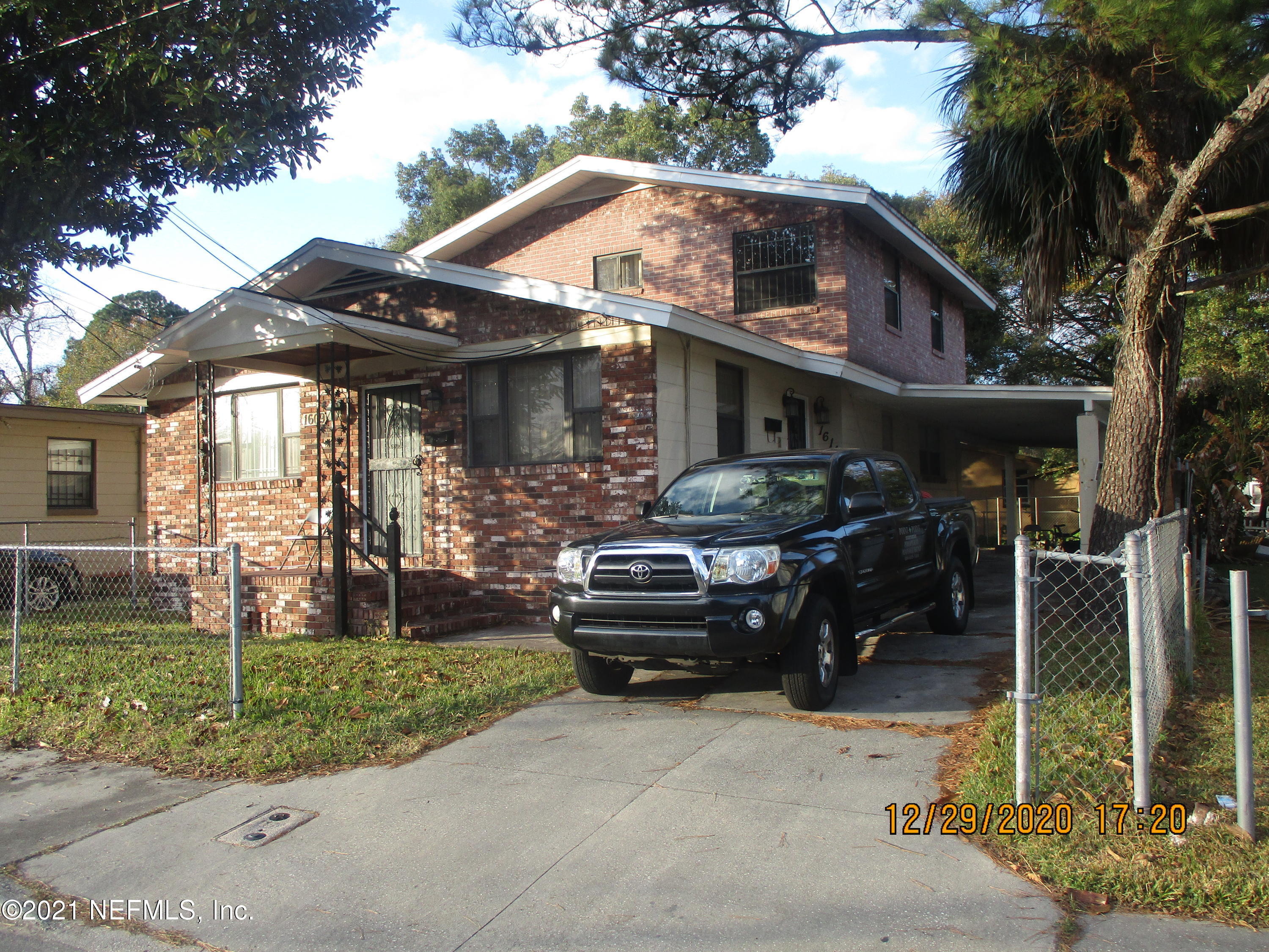 a front view of a house with a garden and plants