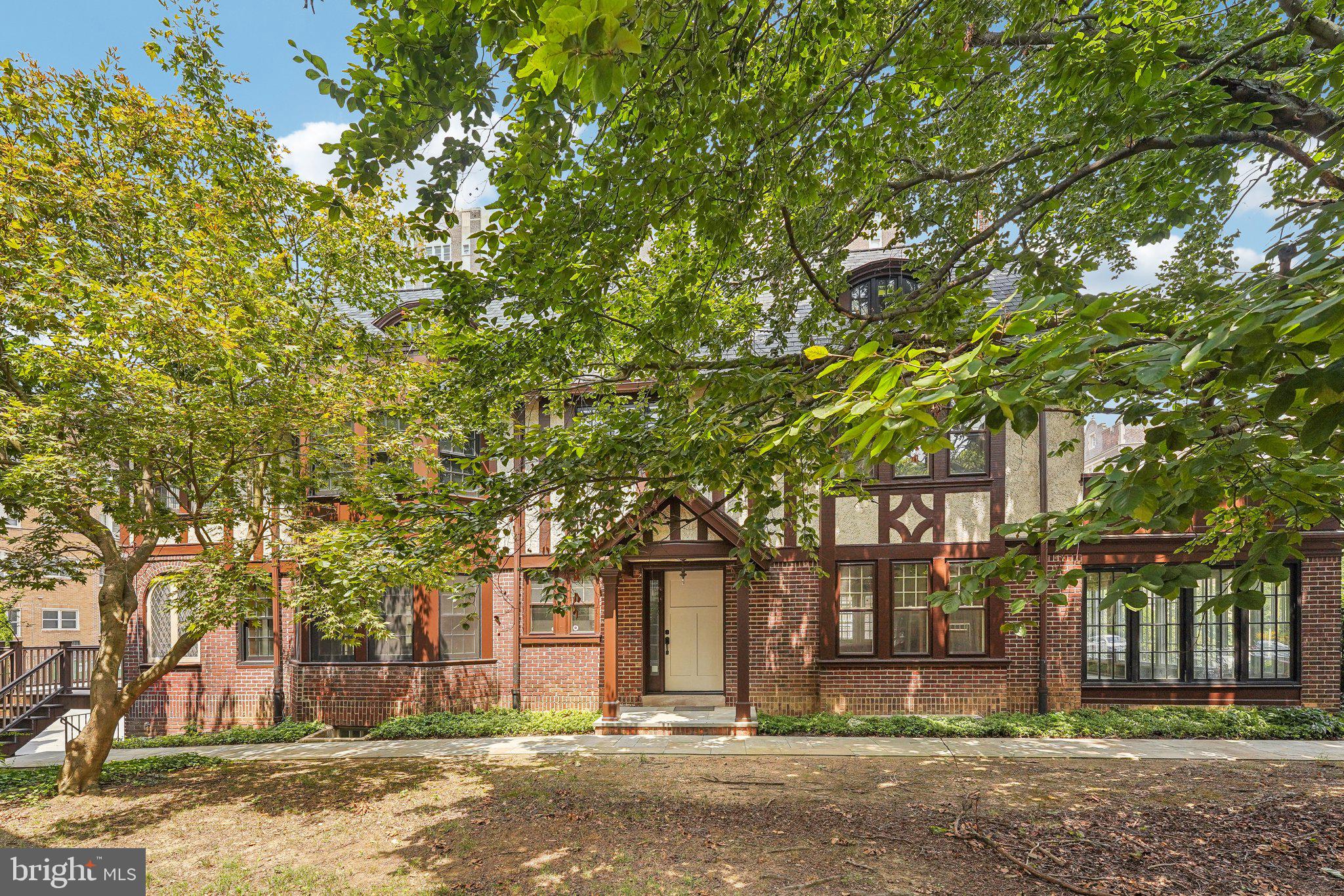 front view of a house with a tree