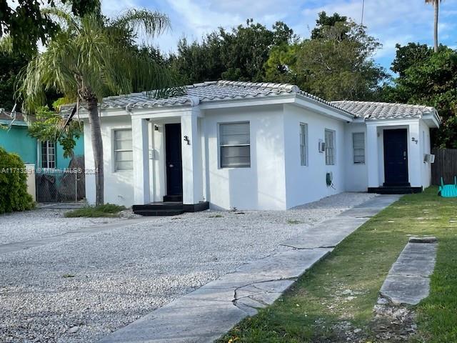 a view of a white house with a yard