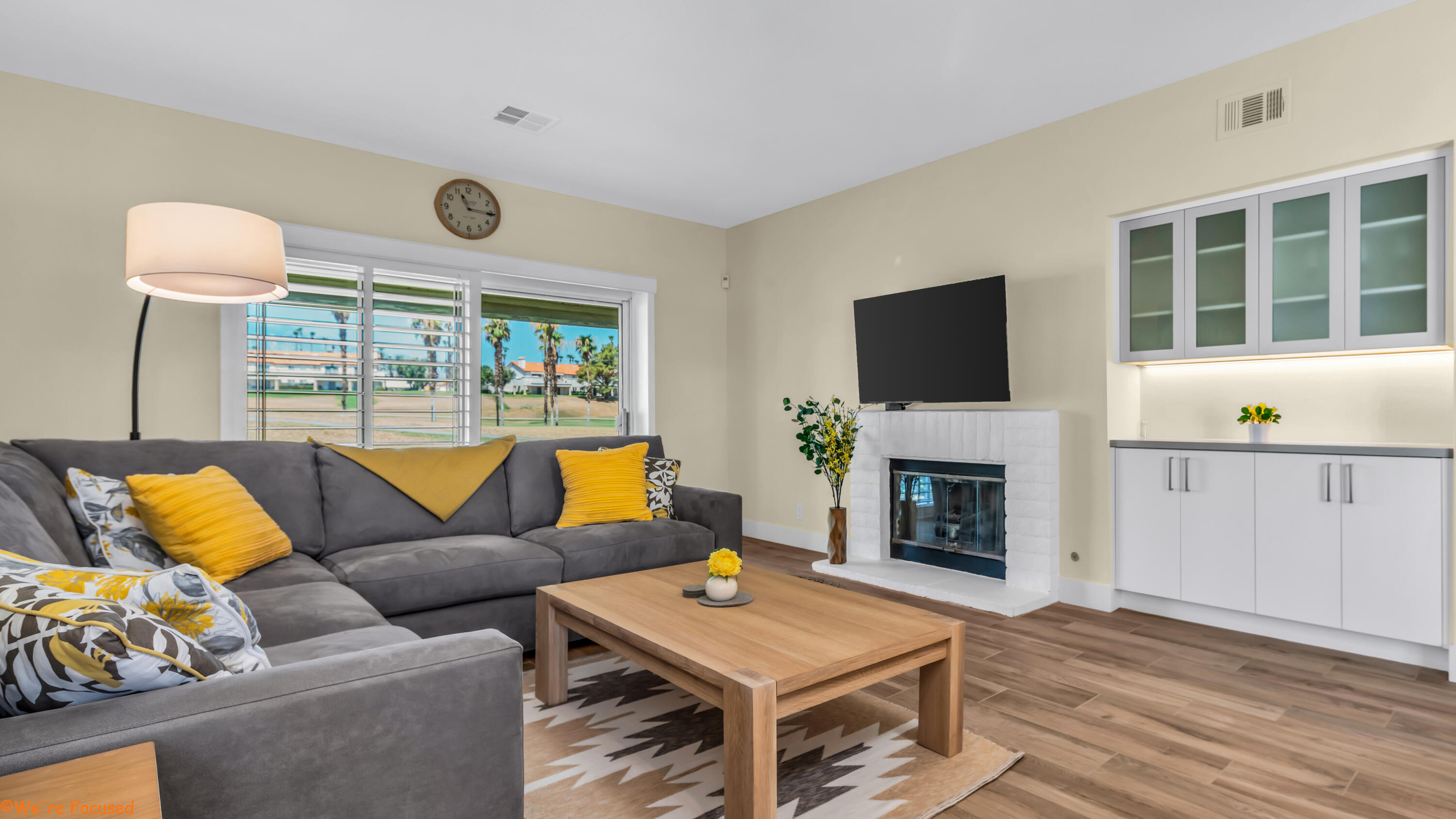 a living room with furniture a fireplace and a flat screen tv