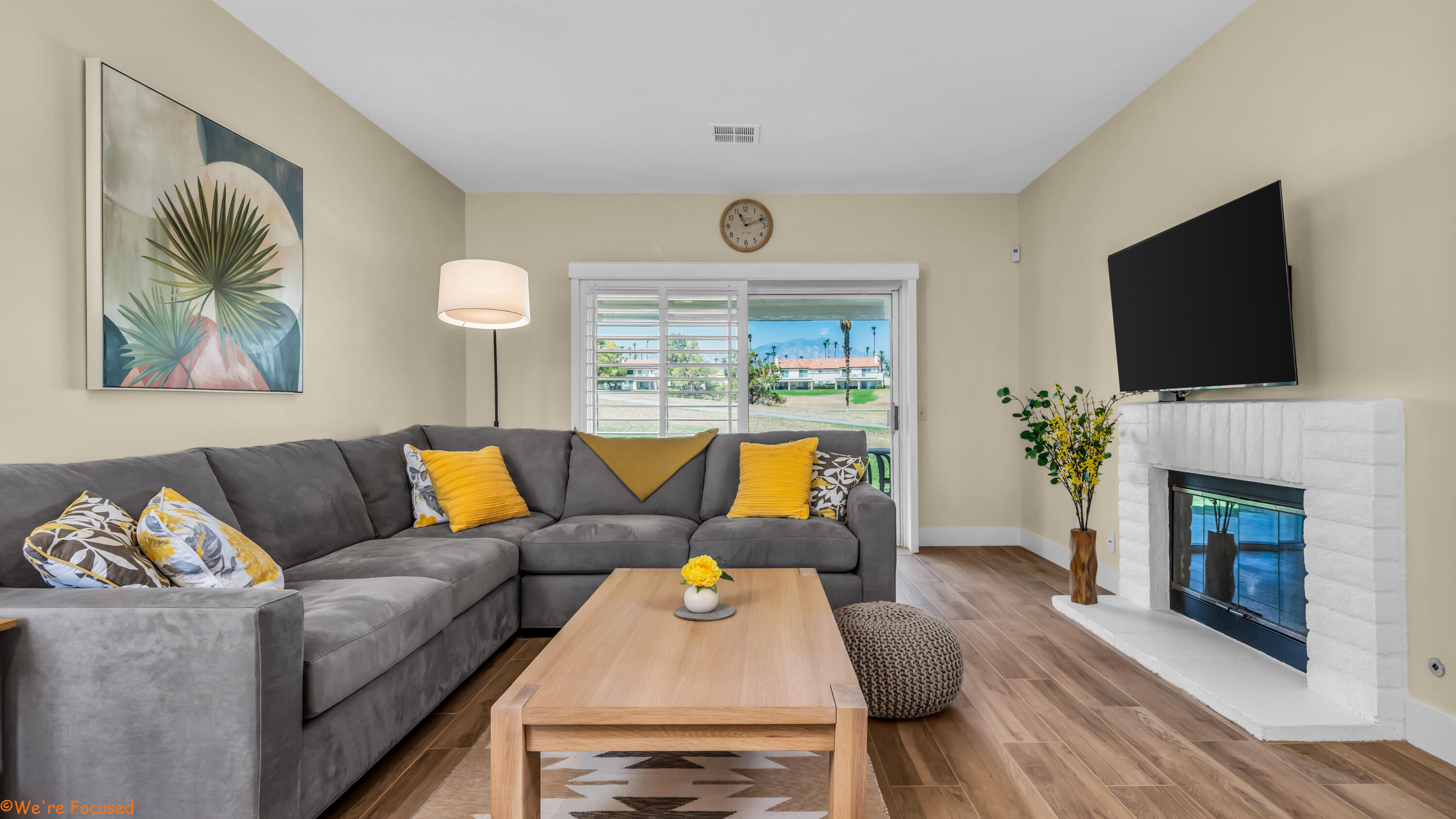 a living room with furniture a fireplace and a flat screen tv