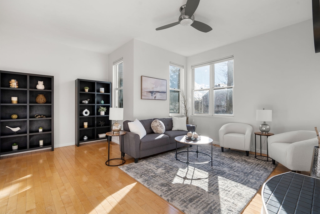 a living room with furniture a rug and white walls