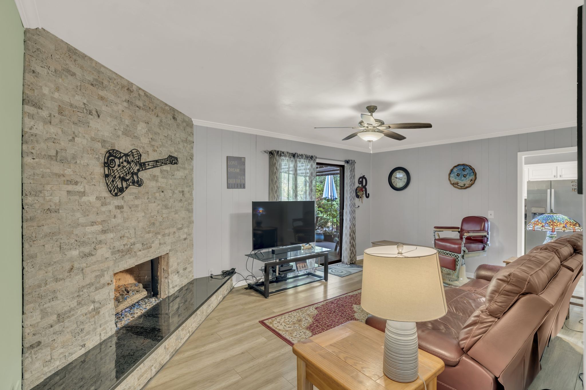 a living room with furniture a flat screen tv and a fireplace