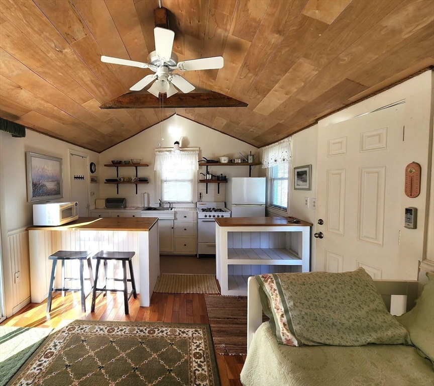 a living room with furniture and kitchen view