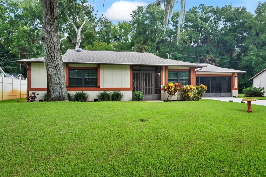 a front view of house with yard and outdoor seating