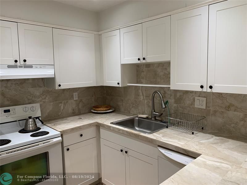 a kitchen with a sink and cabinets