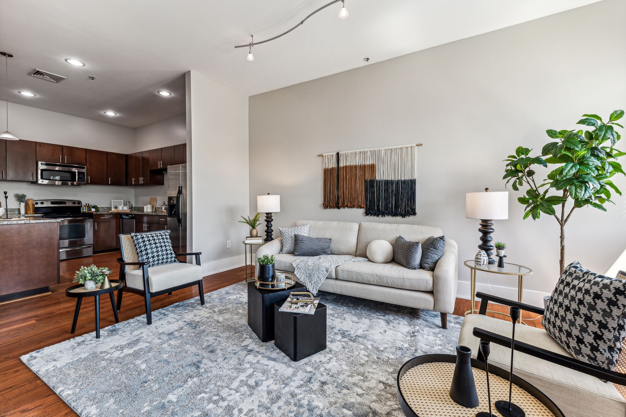 a living room with furniture and wooden floor