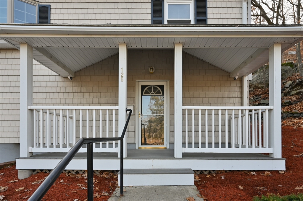 a view of a house with a wooden deck