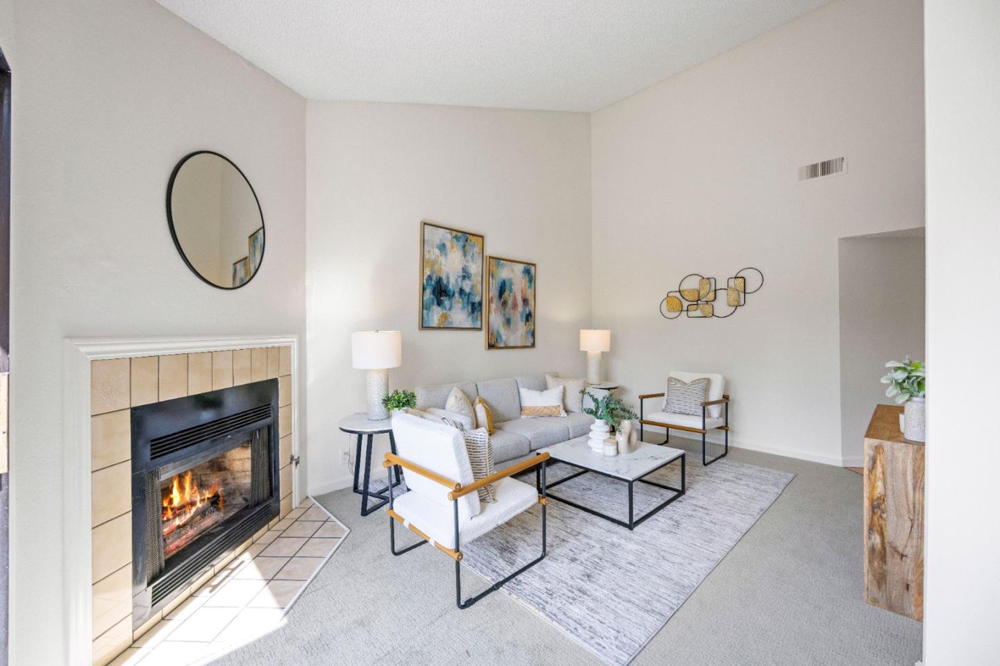 a living room with furniture a fireplace and a window