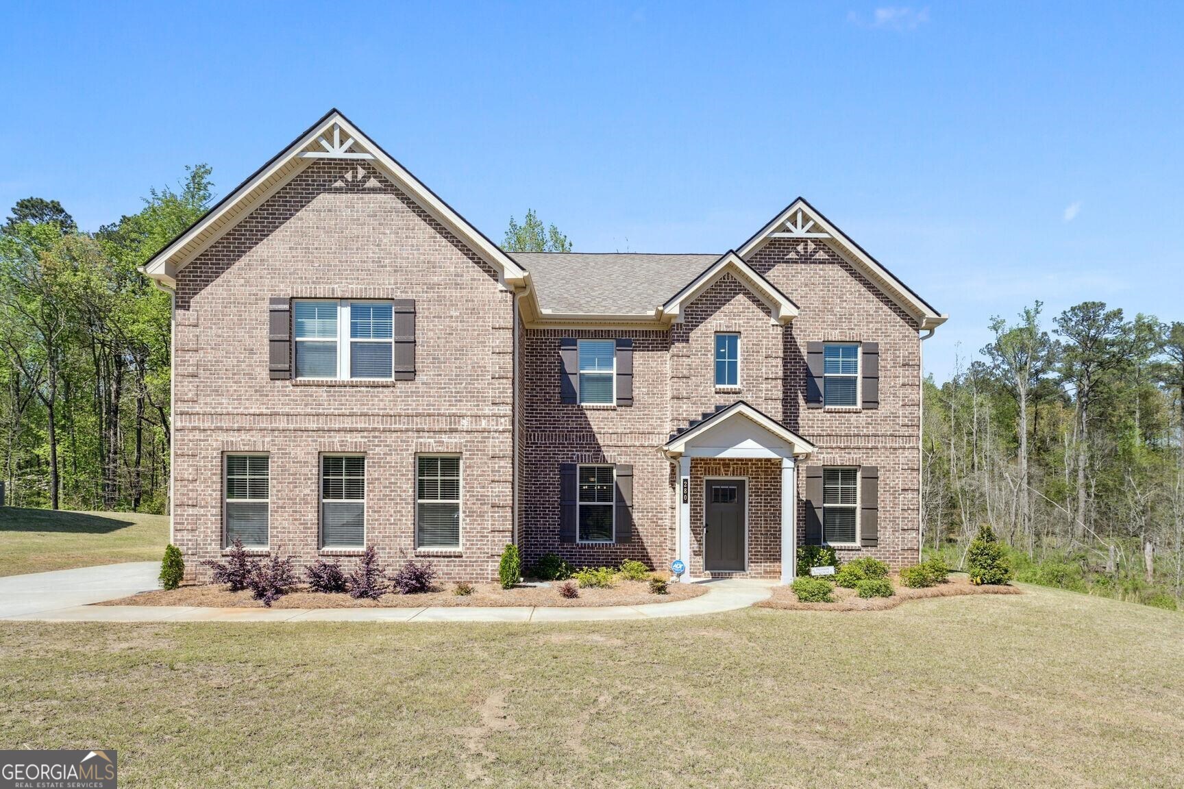 a front view of a house with a yard