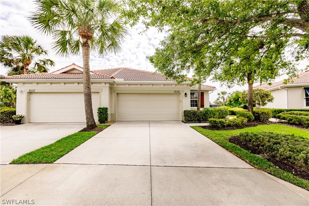 a front view of a house with a garden and a garage